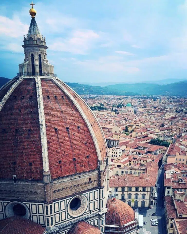 The view from the top of Florence Cathedral (Cattedrale di Santa Maria del Fiore - Duomo di Firenze), Italy, showing the red roof against the cityscape beyond.