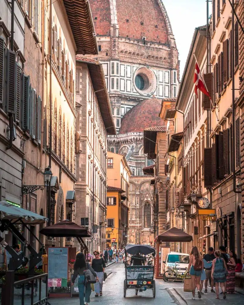 A street in Florence, Northern Italy, with the Florence Cathedral behind (Cattedrale di Santa Maria del Fiore - Duomo di Firenze).