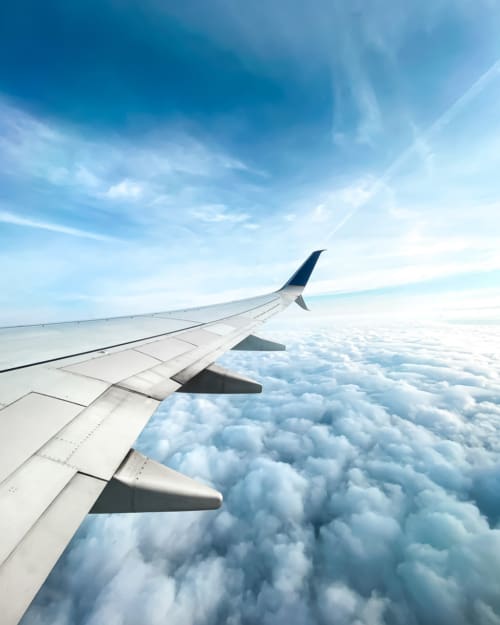 Looking out of the plane window over the clouds