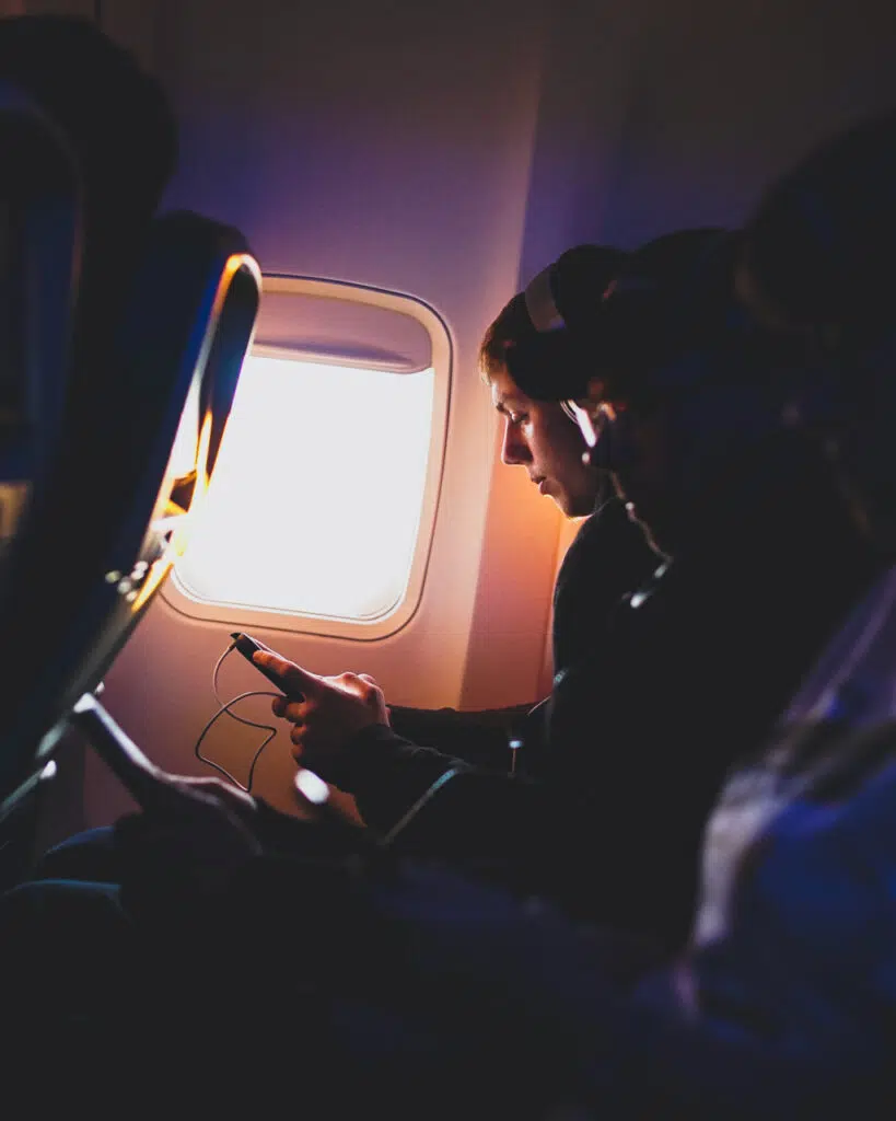 Person browsing phone on a flight