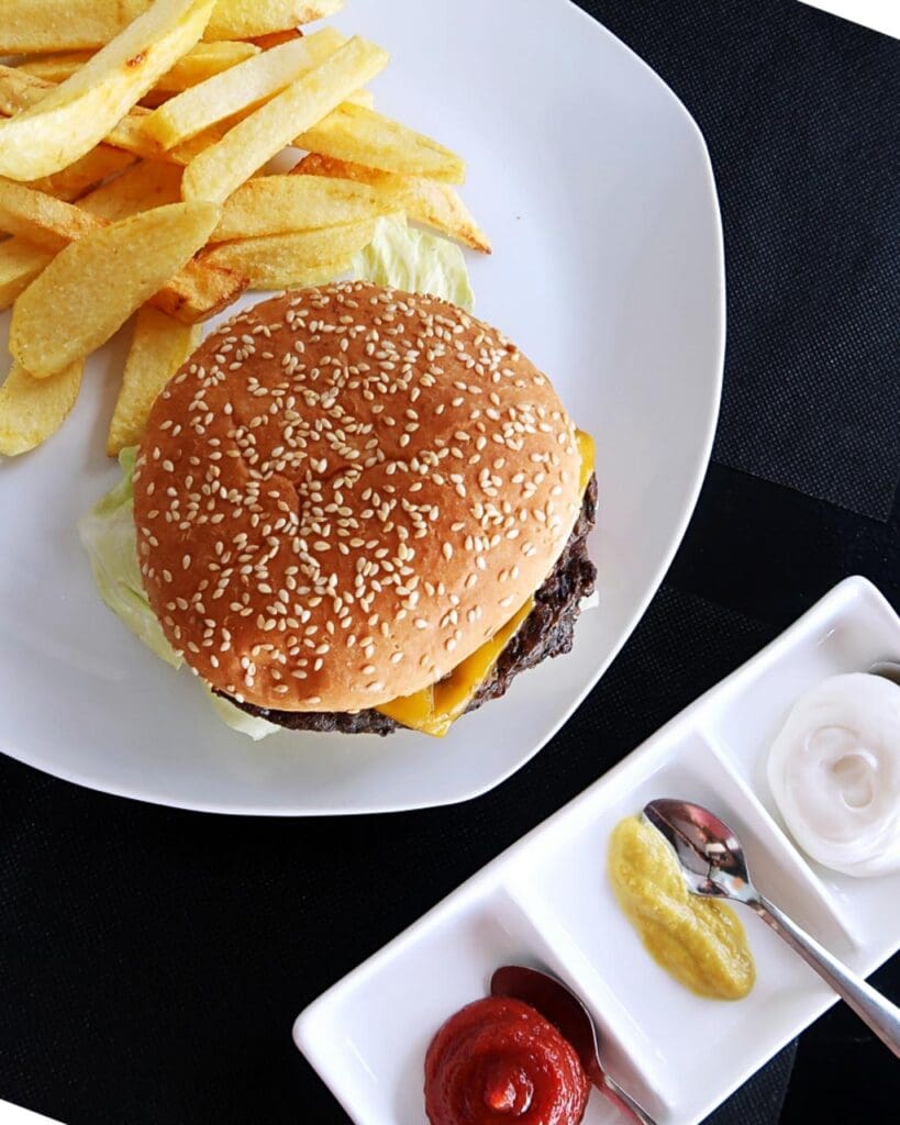 Vegan burger and chips with condiments