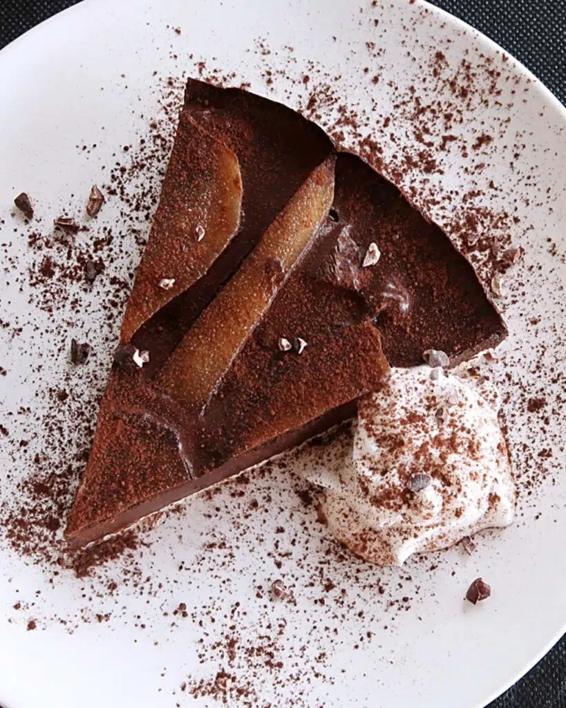 Vegan chocolate and pear torte with whipped cream