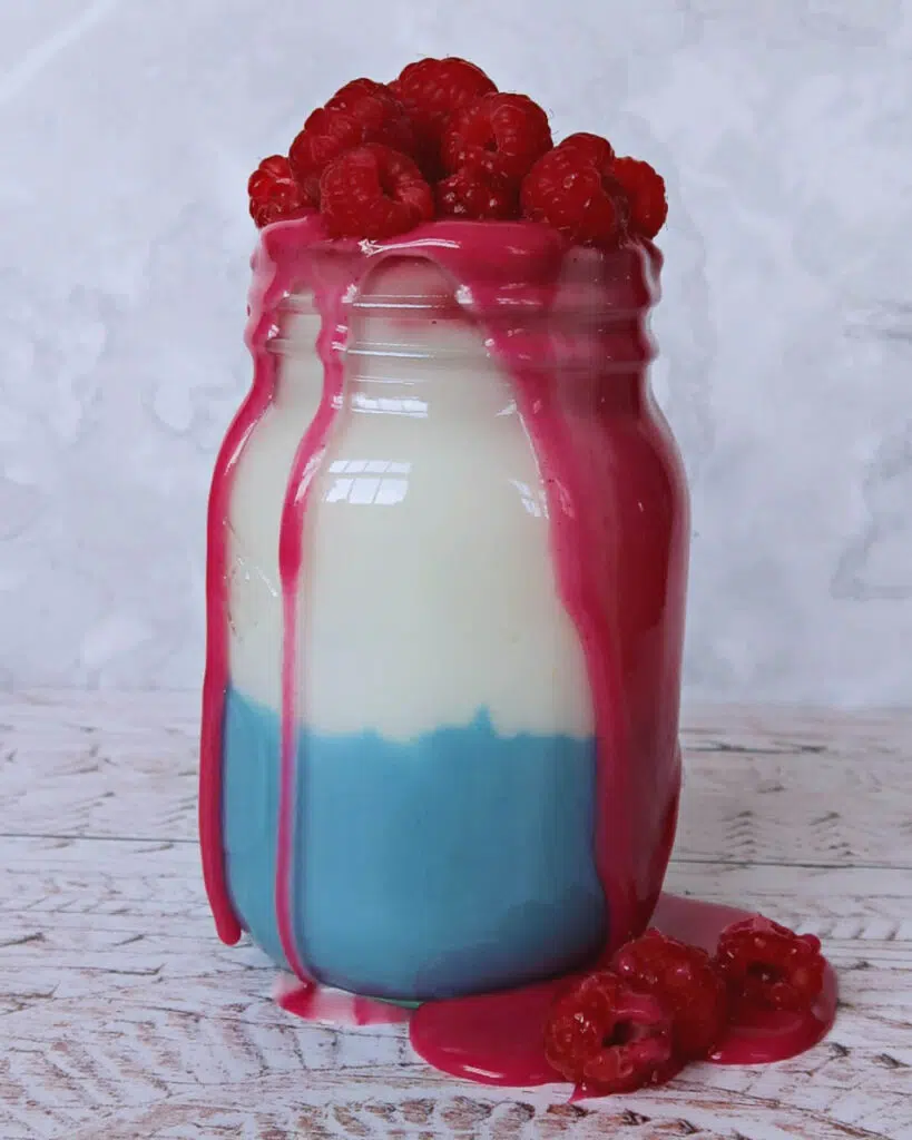 A large jar of blue, white and red icing coloured with natural food colourings