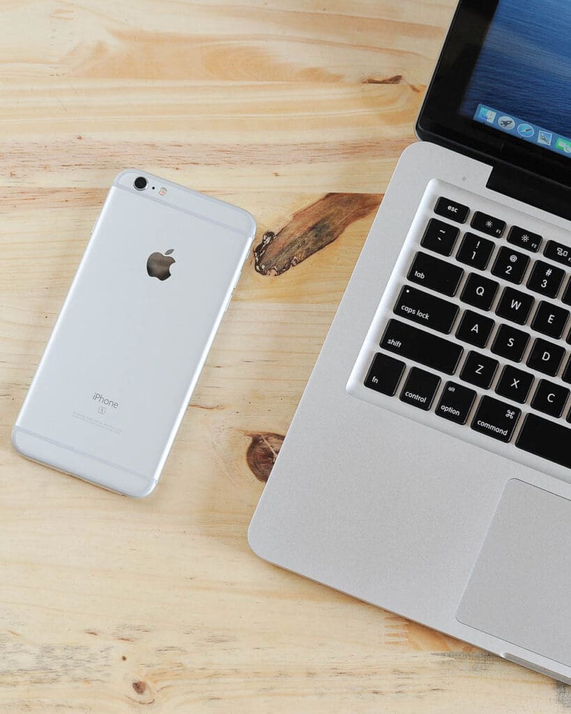 An Apple laptop and phone