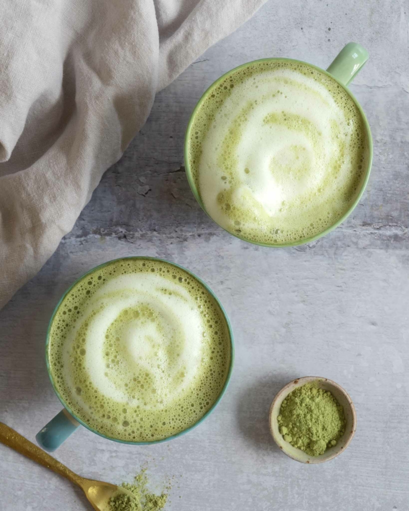 Two cups of matcha latte with frothy oat milk