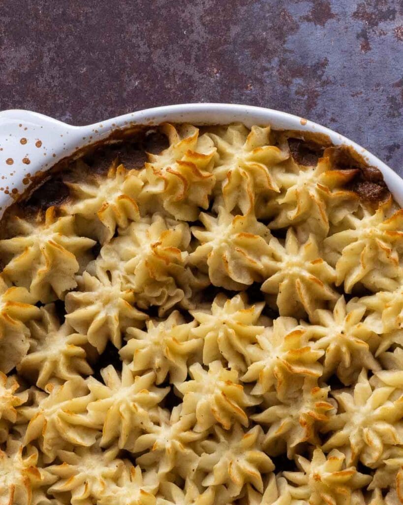 The top of a shepherd's pie with piped mashed potato