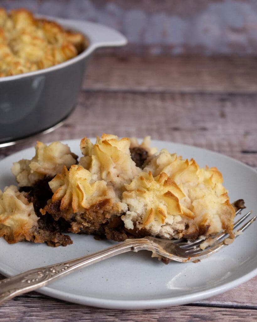 A plate of shepherd's pie with piped mashed potato