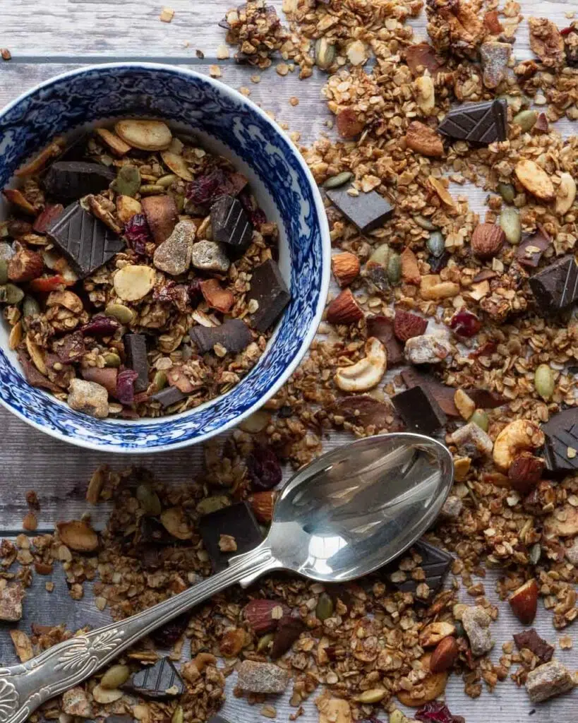 A bowl of healthy vegan granola with chocolate and cranberries