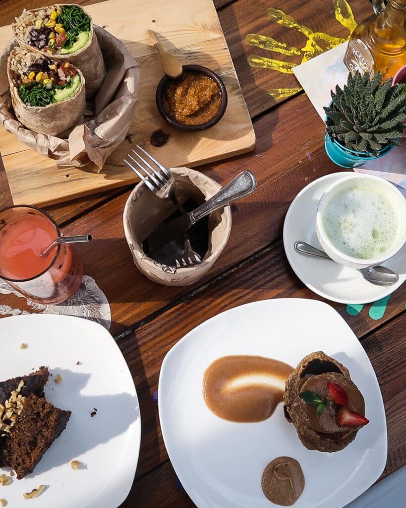 A vegan brunch spread from a vegan restaurant in Santiago, including a wrap, pancakes, cake and coffee