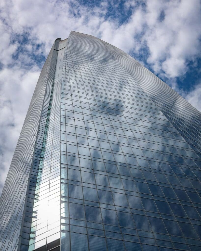 The Sky Costanera Centre from the outside, showing the height and mirrored windows against a blue sky
