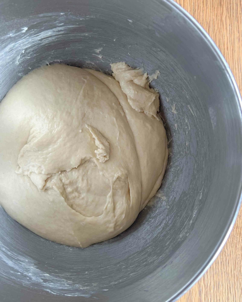 Vegan hot cross bun dough in a mixer bowl