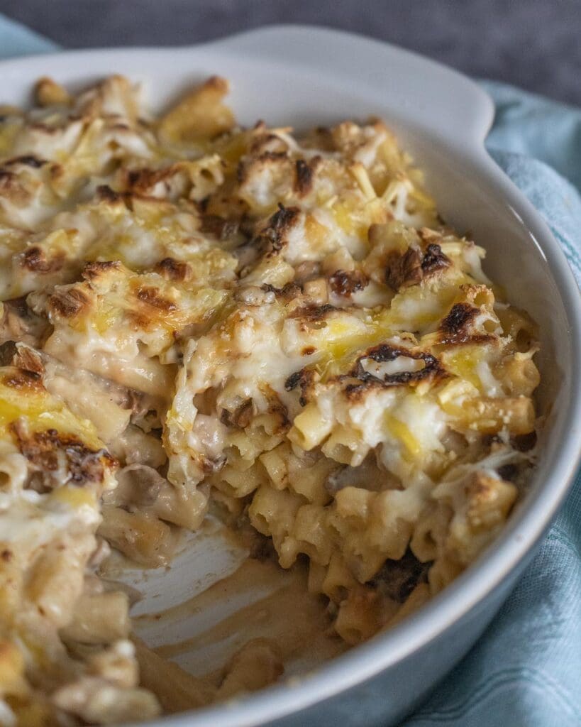 A dish of vegan mac and cheese with melty golden cheese on top
