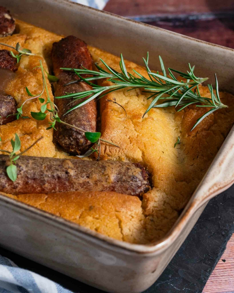 A dish of fluffy and crisp vegan toad in the hole