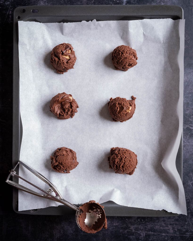 Vegan chocolate chip cookie dough on a baking tray ready to go in the oven
