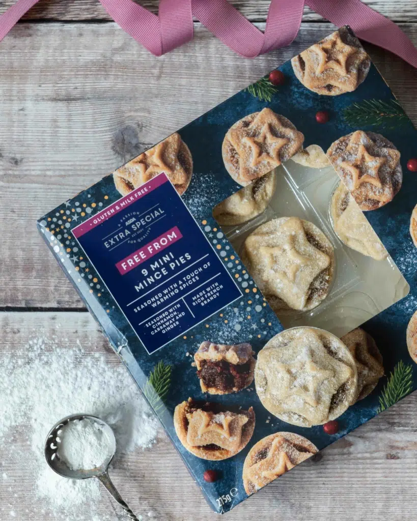 A box of Sainsbury's mini vegan mince pies sat on a wooden tabletop