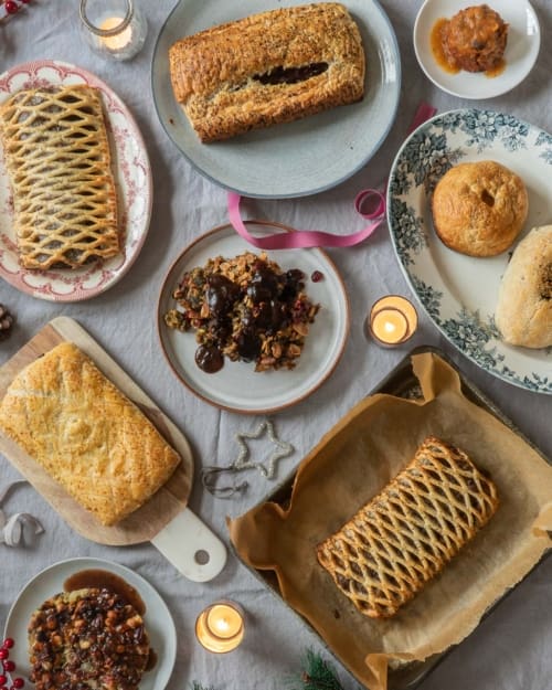 A flat lay of a Christmas dinner table featuring vegan centre pieces