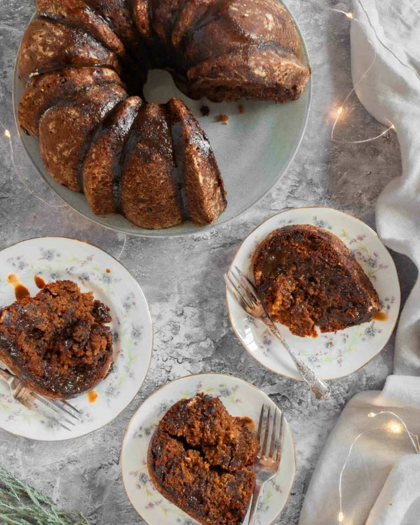 A pretty vegan bundt cake cut into slices on vintage tea plates
