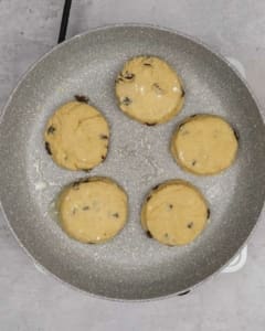 Vegan welsh cakes being fried in a frying pan