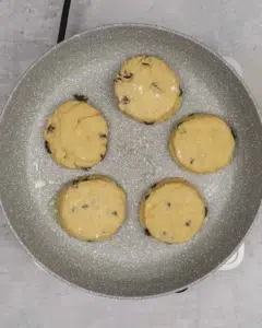 Vegan welsh cakes being fried in a frying pan