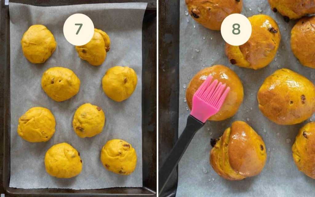 Cornish saffron buns on a baking tray being brushed with glaze