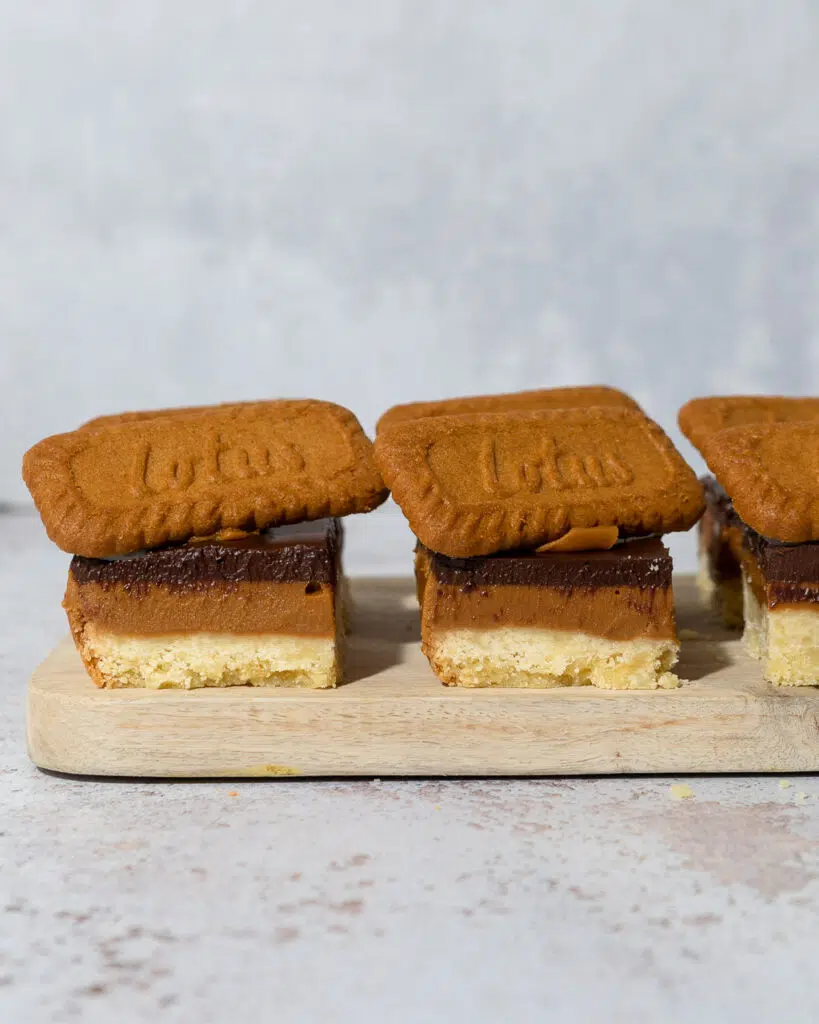 Biscoff Billionaire's Shortbreads with a trio of layers - vegan shortbread, biscoff spread and dark chocolate topped with a Lotus Biscoff biscuit
