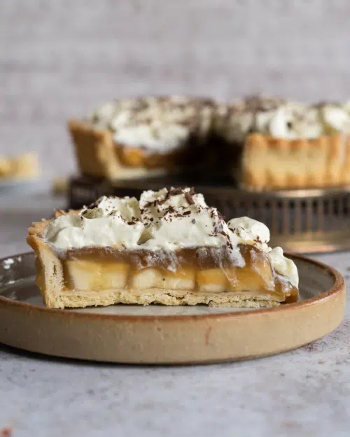 A slice of the best vegan Banoffee Pie on a rustic plate