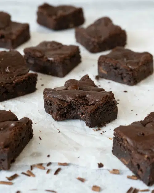 Squares of rich fudgey vegan chocolate brownie studded with dark chocolate chips