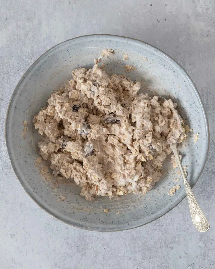 The oat and yoghurt base for blueberry muffin bircher stirred together in a bowl