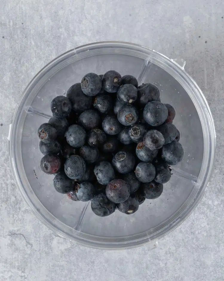 Fresh blueberries in a blender cup
