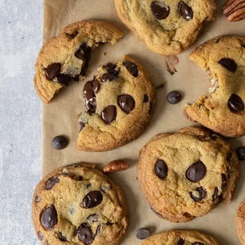 Deliciously soft and chewy vegan cookies fresh from the oven with melty chocolate chips and caramelised pecan pieces