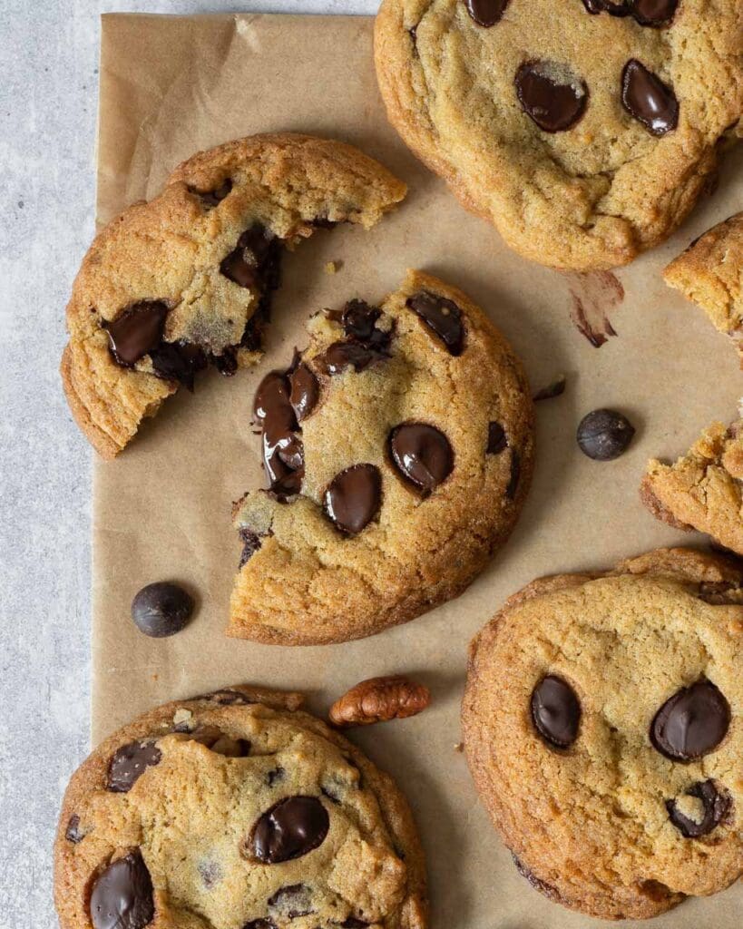 Deliciously soft and chewy vegan cookies fresh from the oven with melty chocolate chips and caramelised pecan pieces