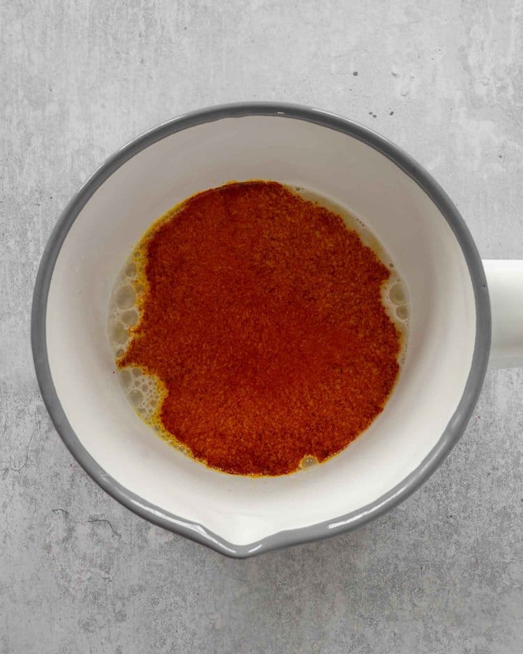 Ground saffron in a saucepan of dairy free milk