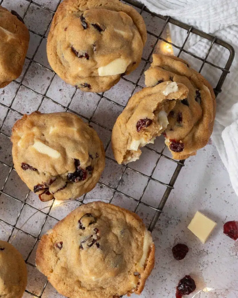 Vegan white chocolate and cranberry cookies on a cooling rack