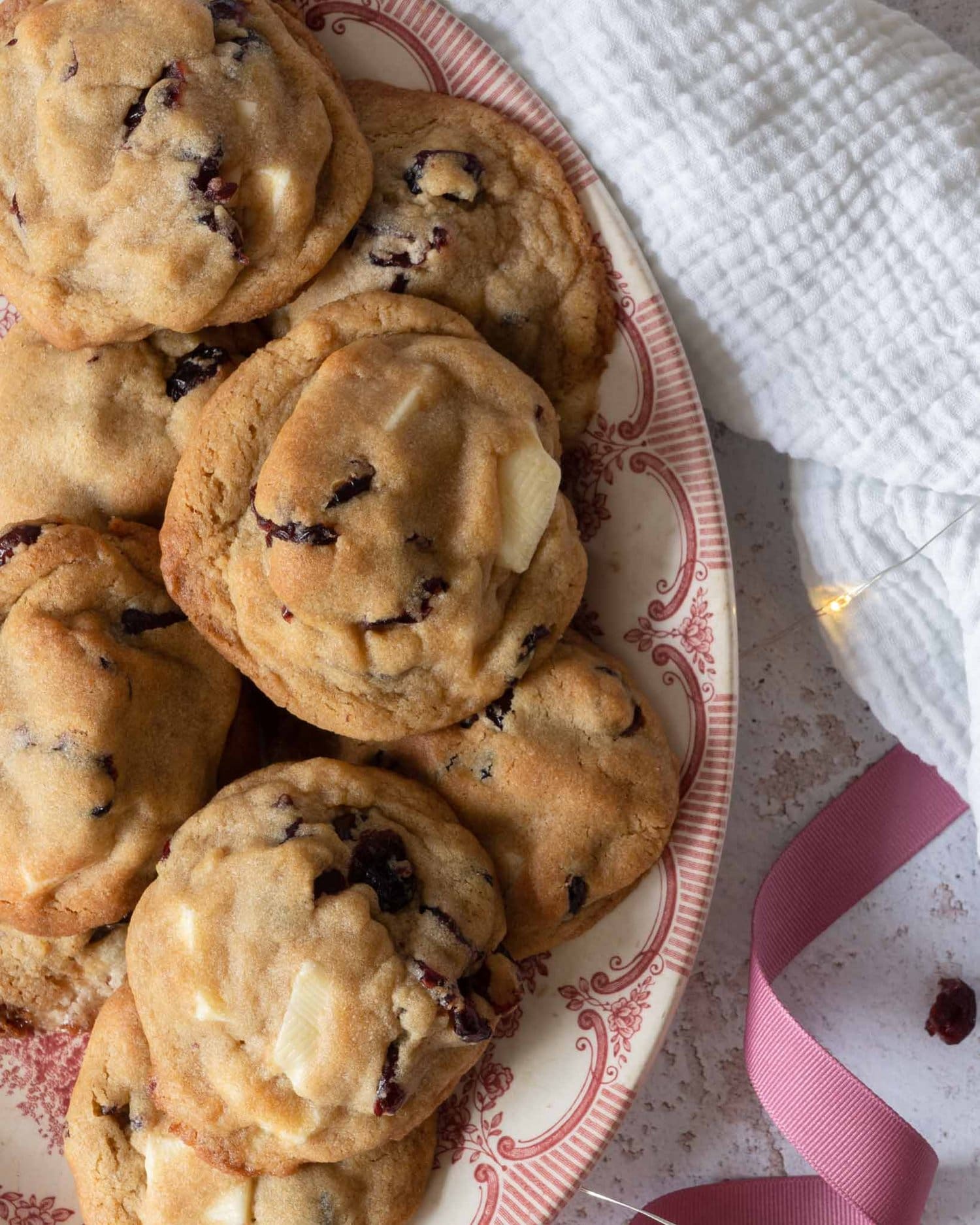 Cranberry and white chocolate cookies on a pretty pink vintage plate