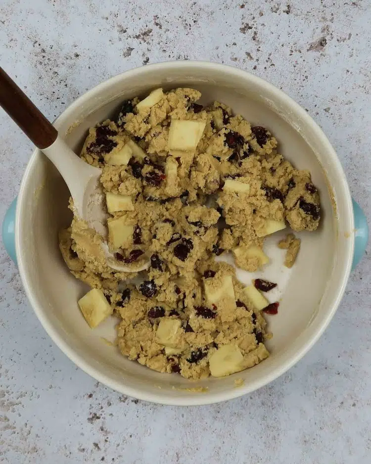 Vegan white chocolate and cranberry cookie dough in a large mixing bowl