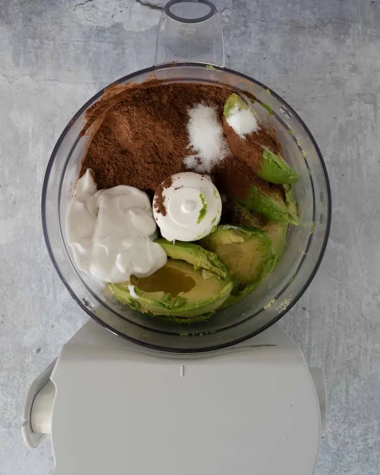 Avocado, coconut cream, cocoa powder and other ingredients in a blender