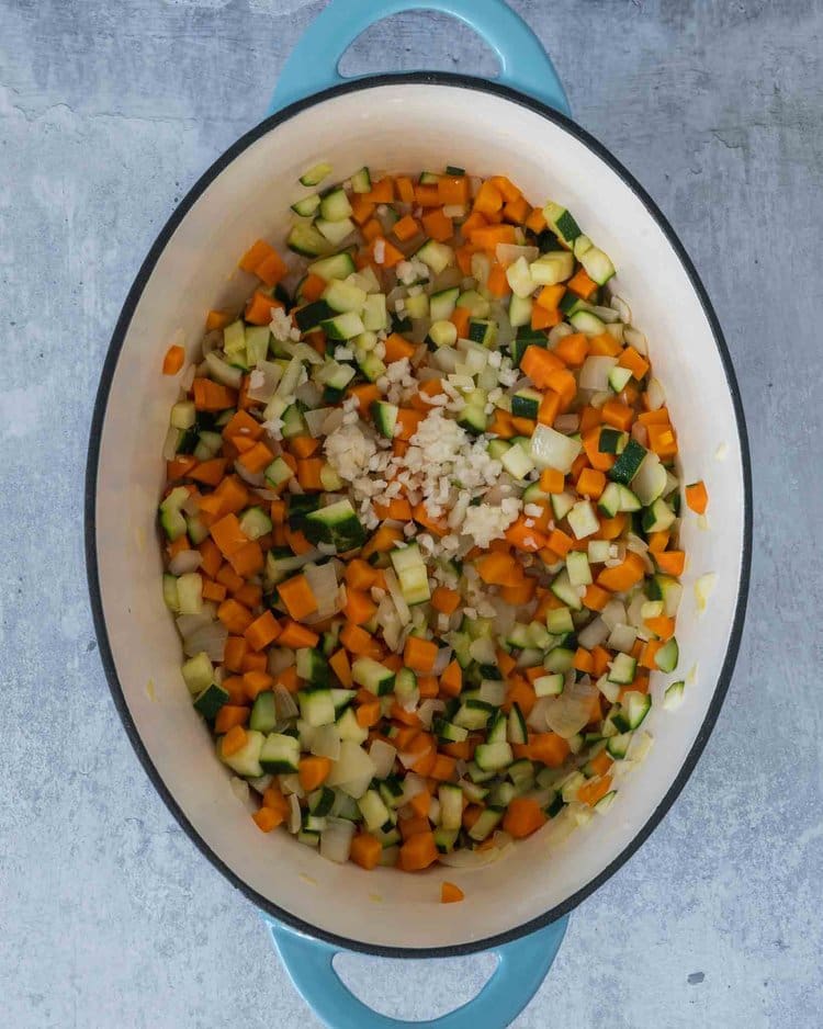 Lightly fried finely diced vegetables and minced garlic in a large saucepan