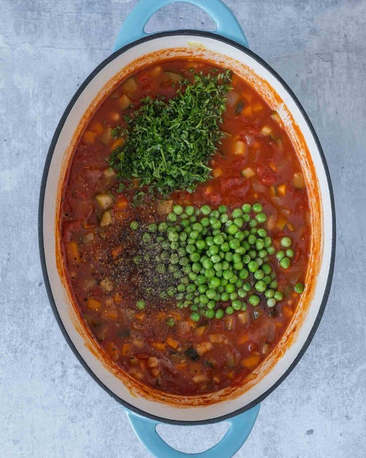 The ingredients for making farmhouse vegetable soup in a large saucepan