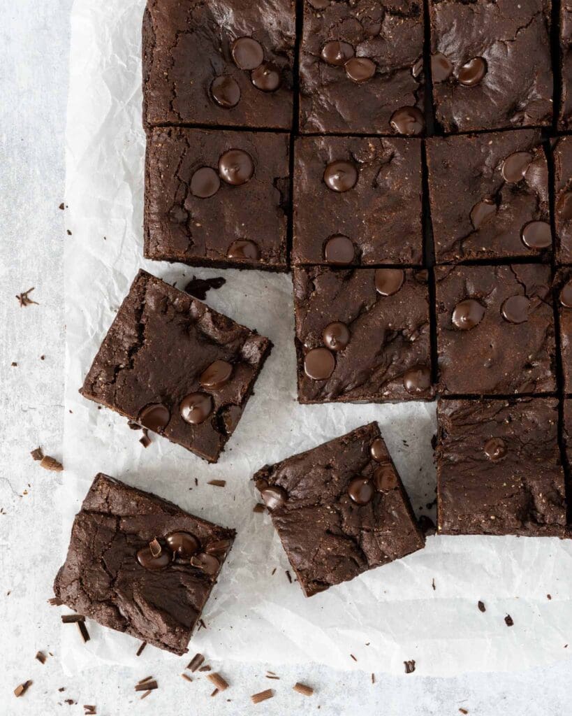 Squares of rich fudgey vegan chocolate brownie studded with dark chocolate chips