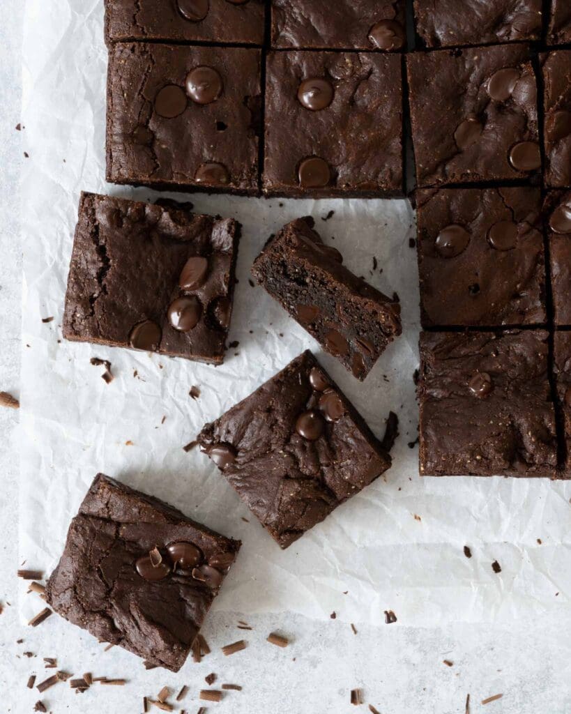 Squares of rich fudgey vegan chocolate brownie studded with dark chocolate chips