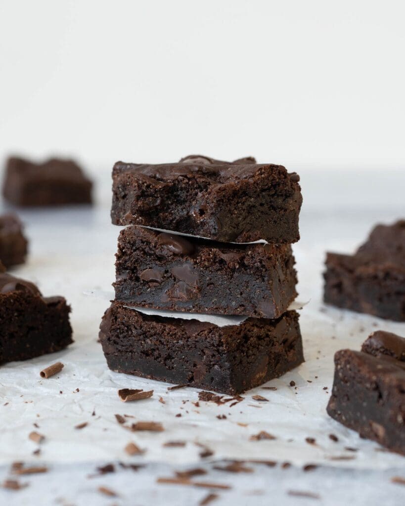 Squares of rich fudgey vegan chocolate brownie studded with dark chocolate chips