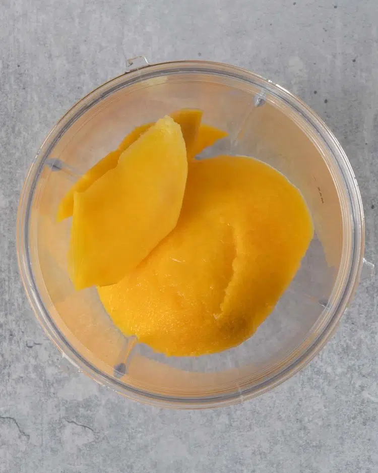 Fresh mango in a blender cup