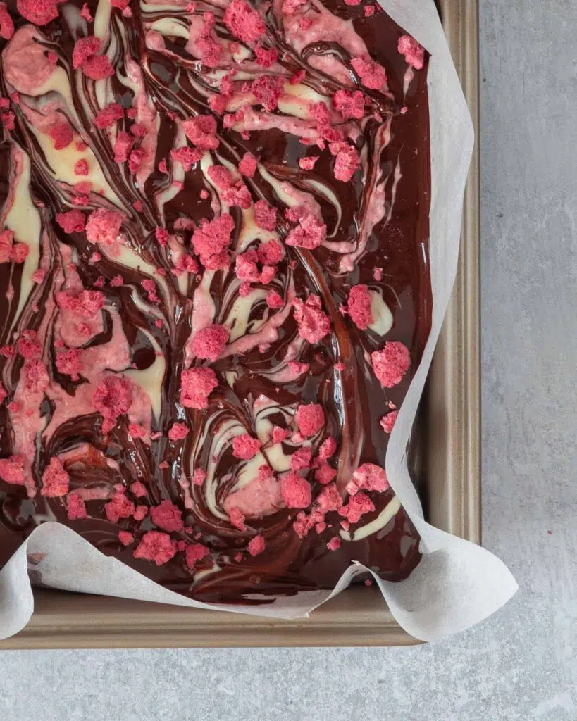 Melted dark chocolate swirled with melted white chocolate, raspberry chocolate and tangy freeze dried raspberry pieces