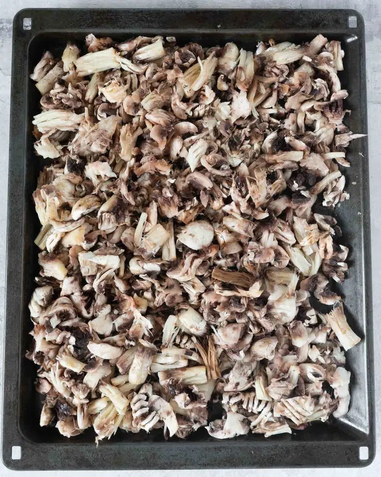 Shredded mushrooms on a baking tray
