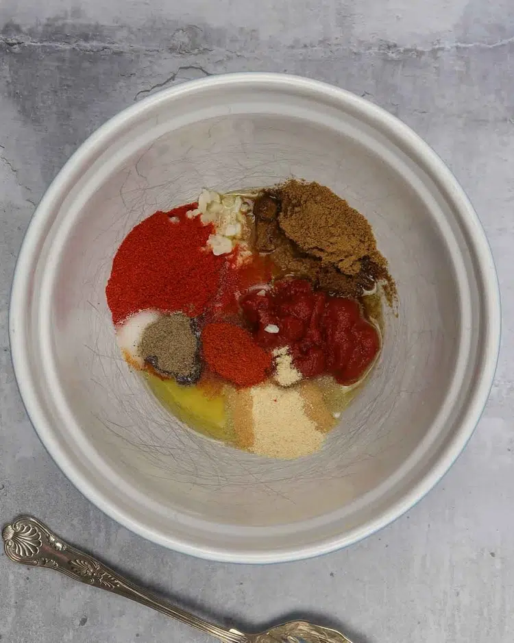 Spices and olive oil in a large bowl ready to be stirred together