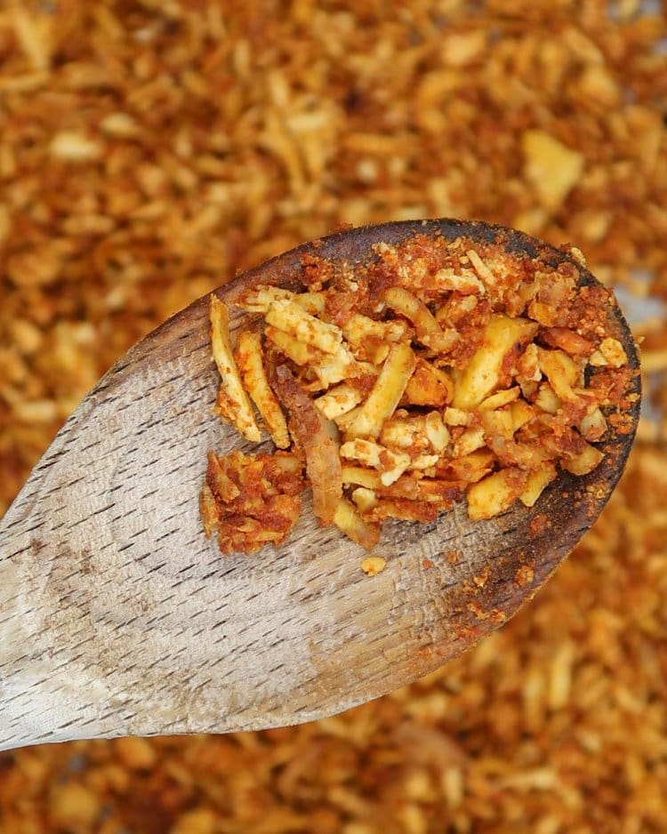 Shredded tofu kebab 'meat' on a wooden spoon after it has been roasted