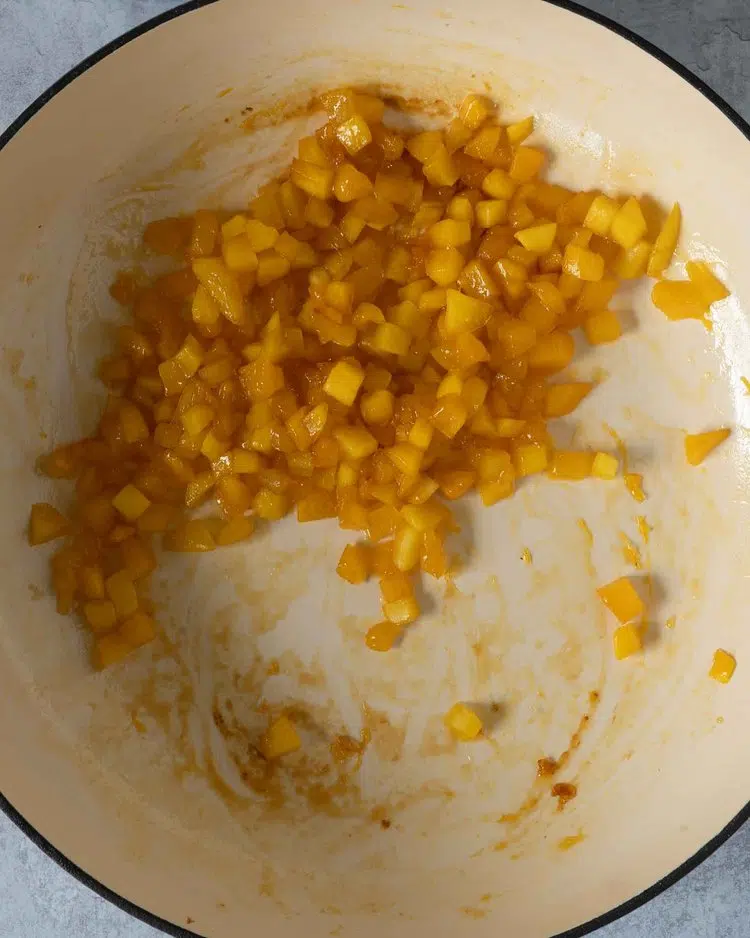 Sticky diced mango in a frying pan
