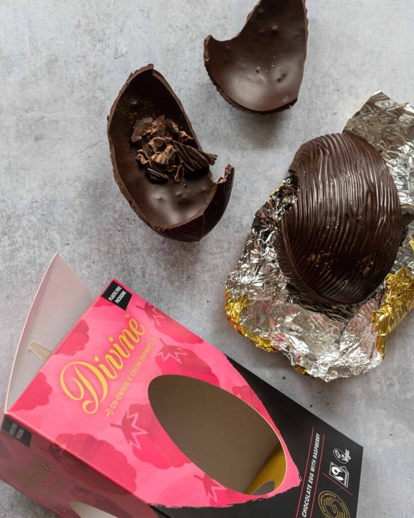 Divine Dark Chocolate Raspberry Easter egg broken open on a table top