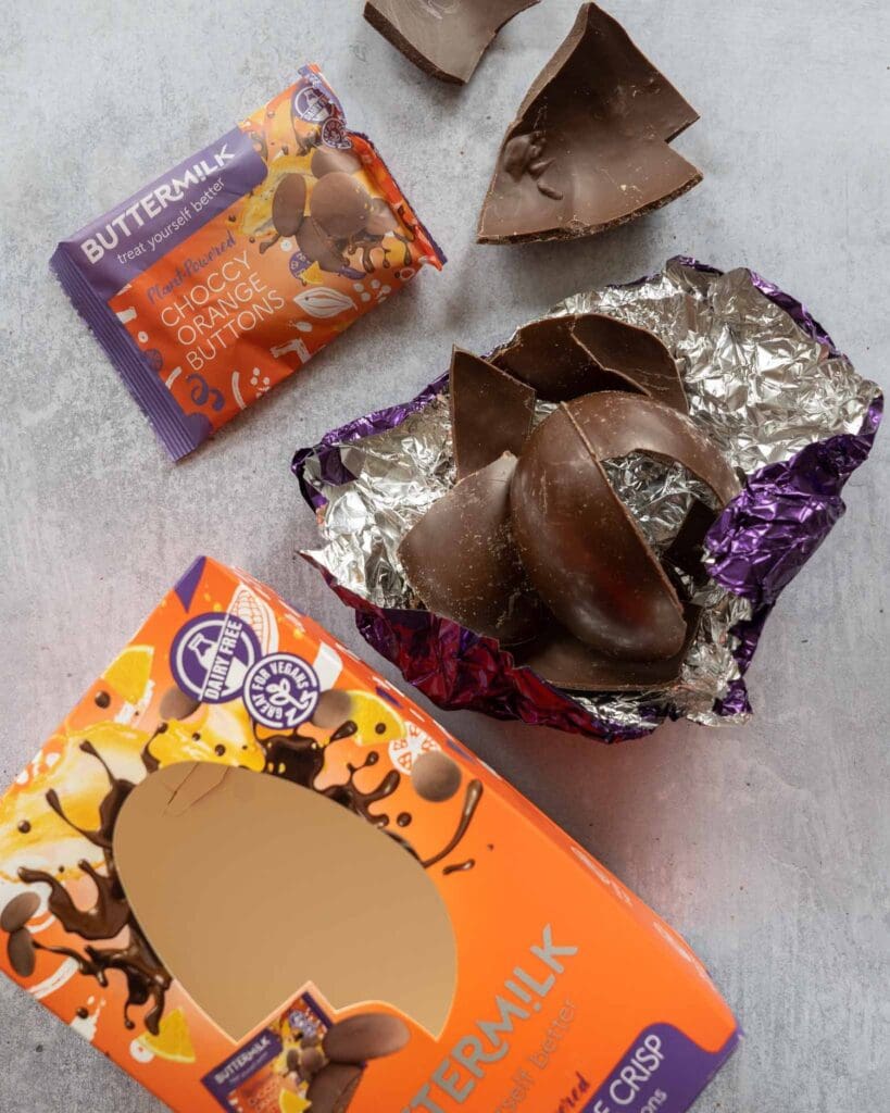 Buttermilk Zingy Orange Crisp Choccy Easter egg broken open on a table top