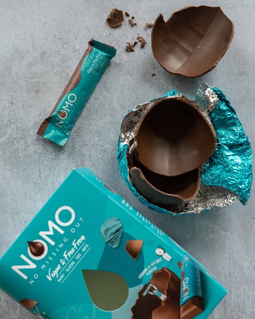 Nomo Caramel Sea Salt Easter egg broken open on a table top